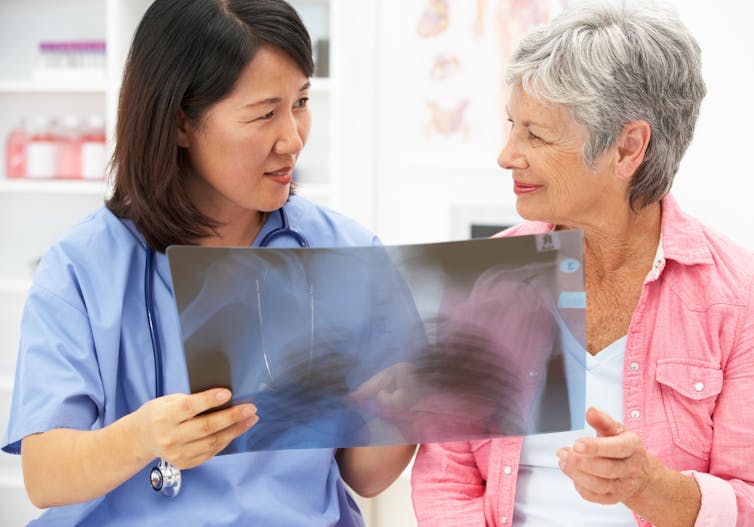 Nurse and patient looking at an x-ray