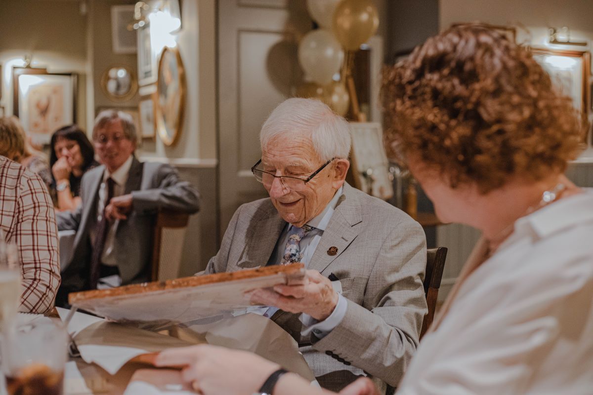 Old man opening a birthday gift