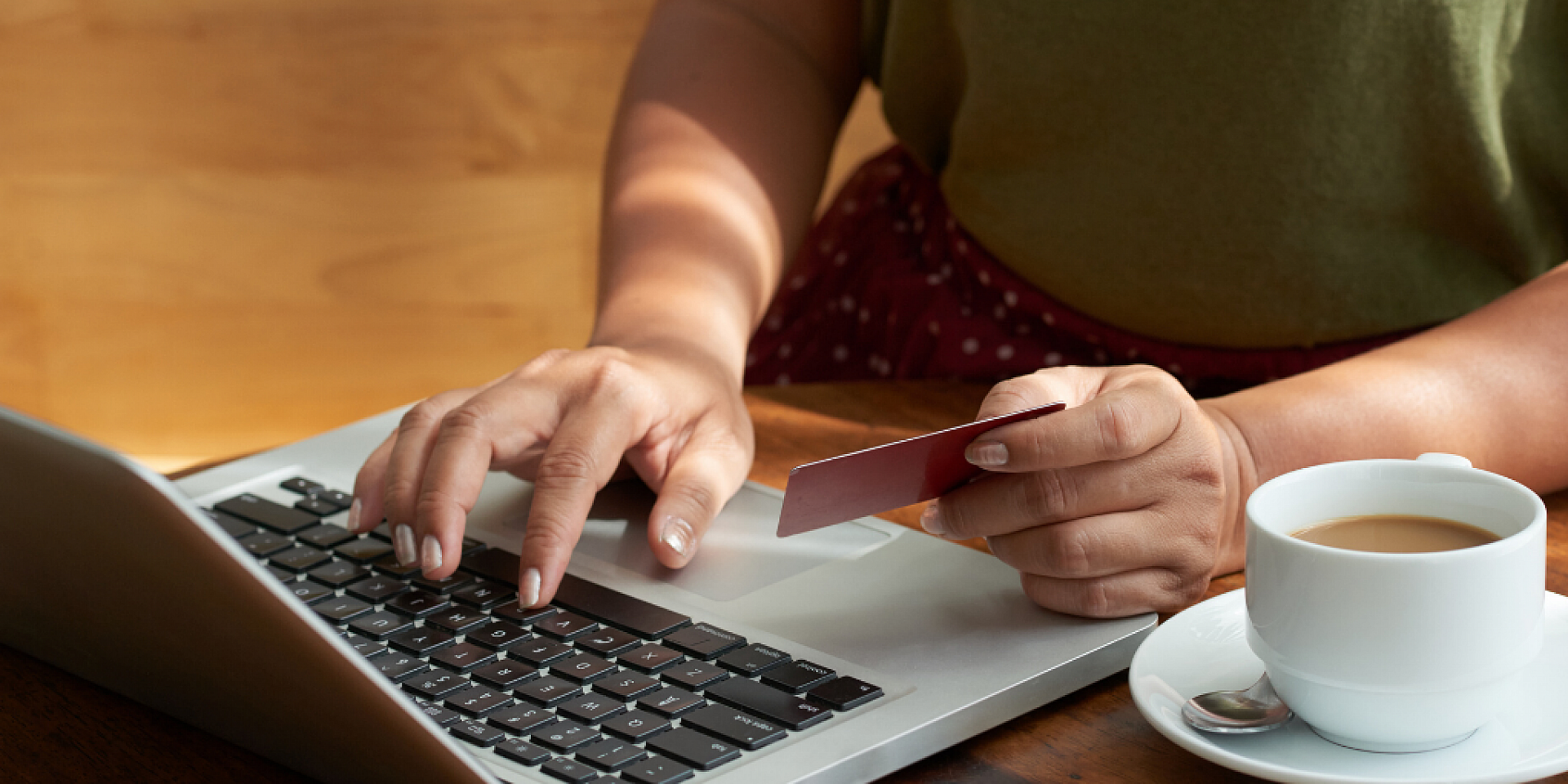 person shopping online holding credit card