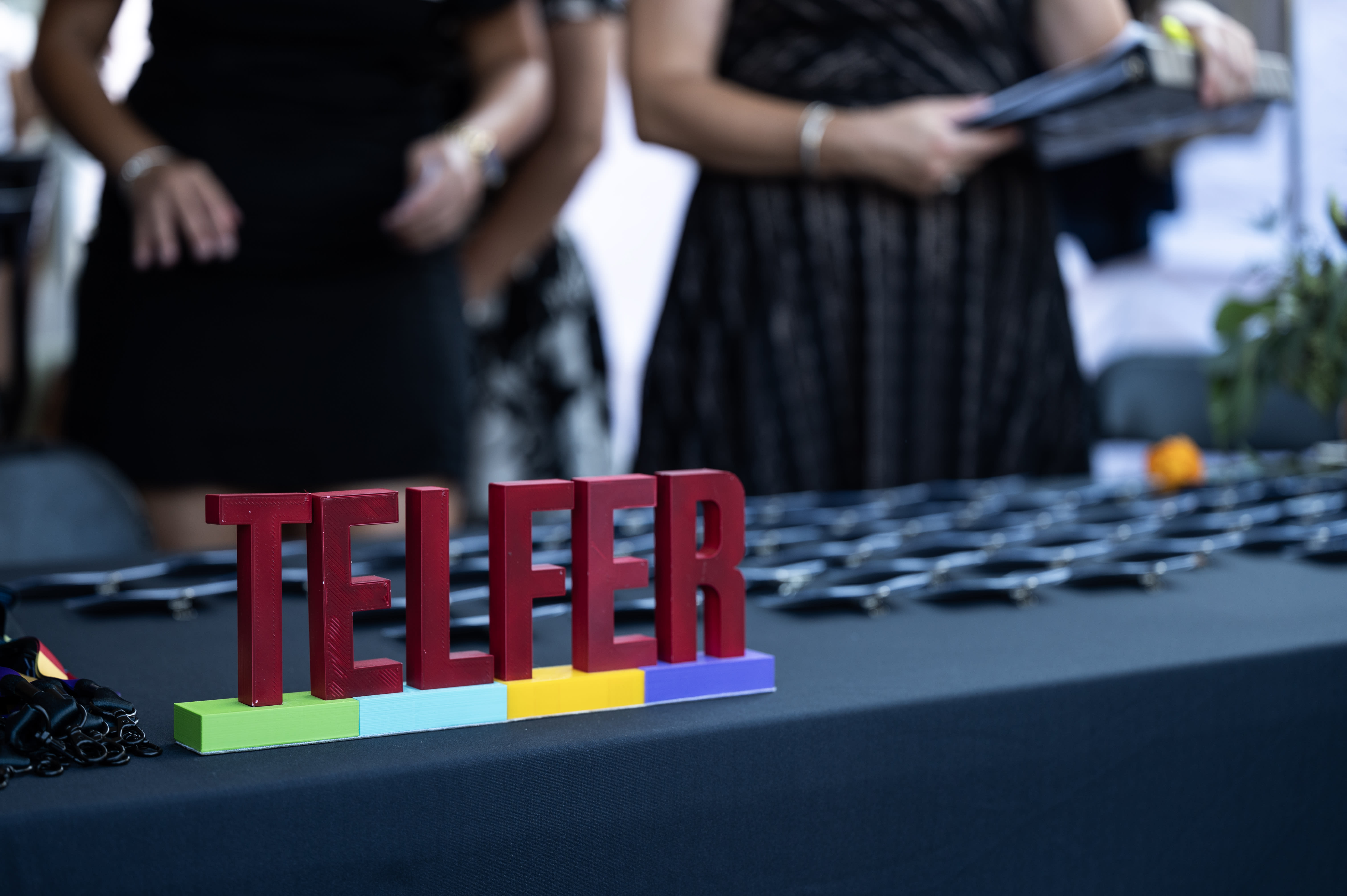 Small Telfer letter sign on a black tablecloth