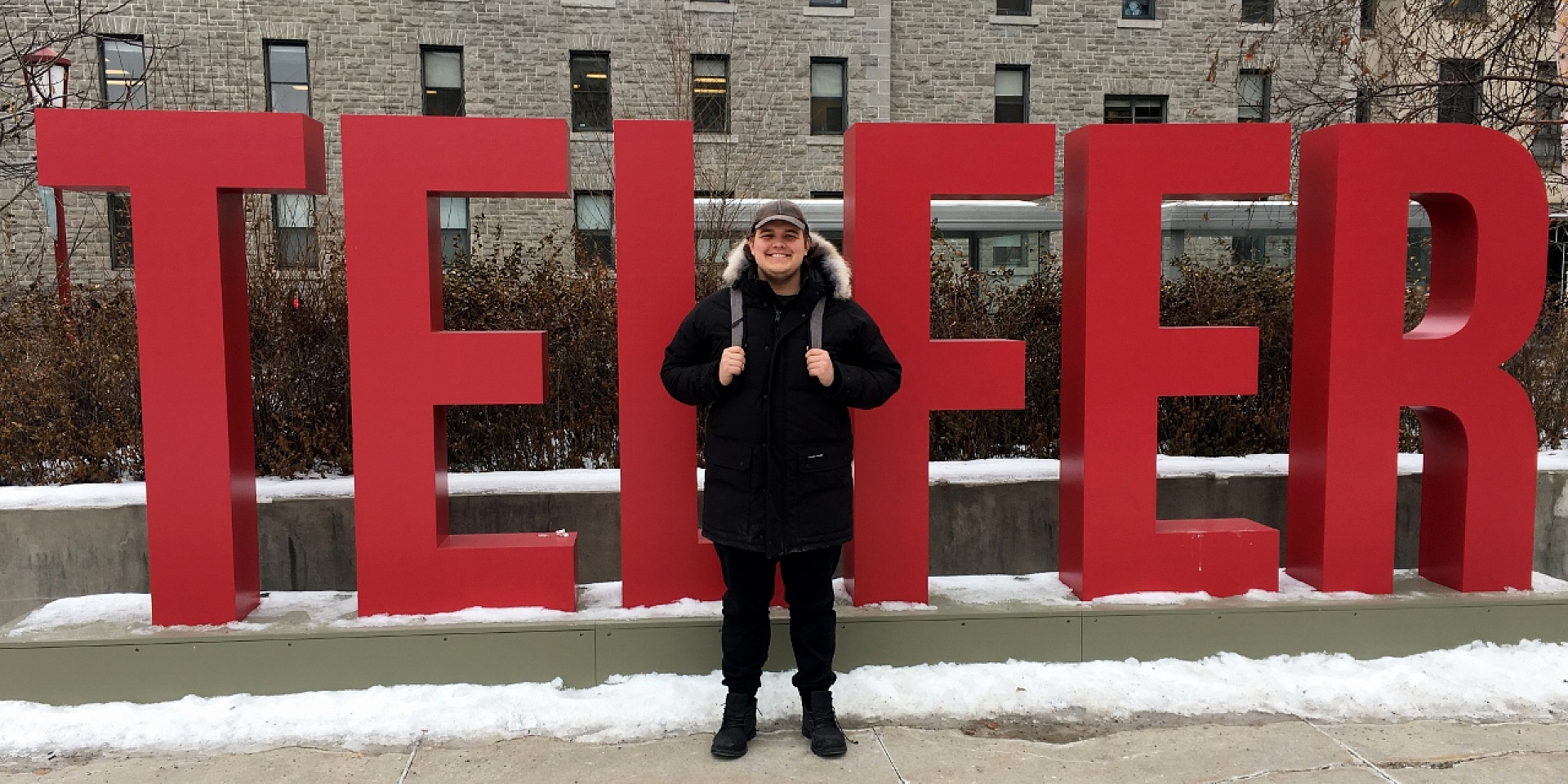 Ryan Lloy in front of Telfer sign