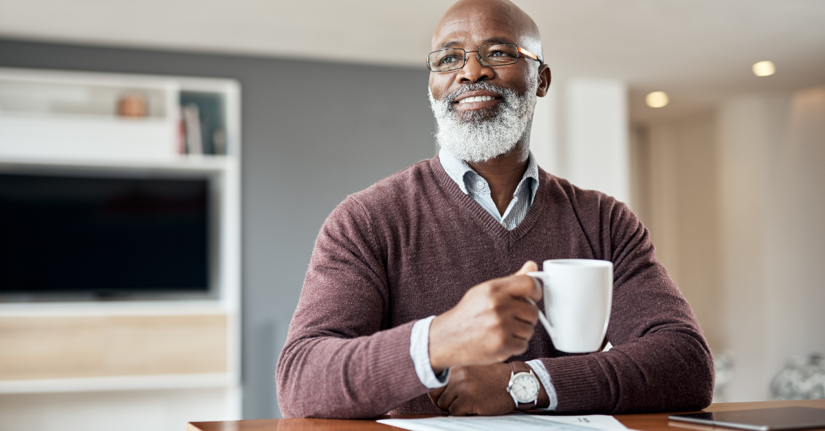 Satisfied elderly man holding a coffee mug