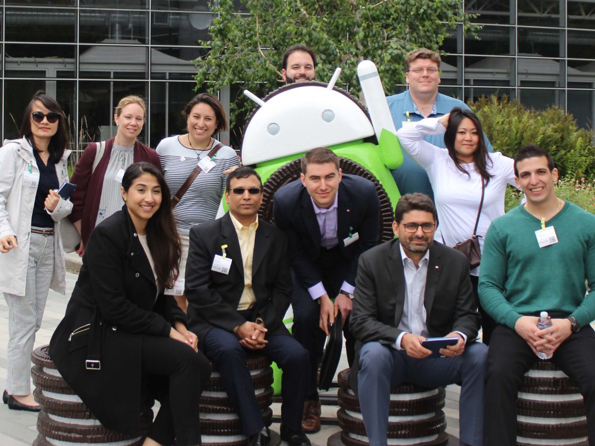 Telfer Executive MBA candidates sitting with Google Android statue in front of Google Headquarters in Silicon Valley
