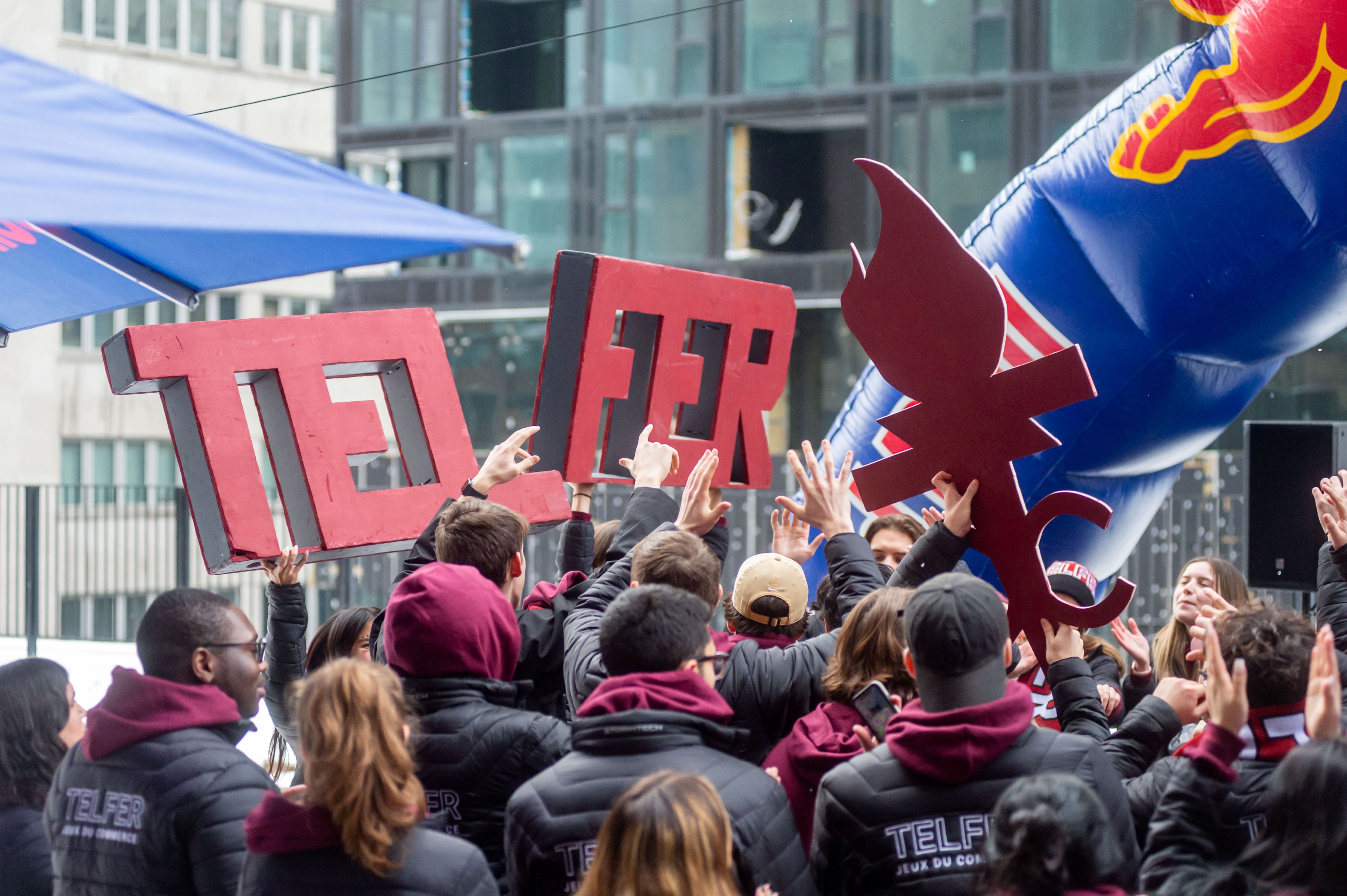 Telfer students arriving at a business case competition carrying the “Telfer” name in big letters, along with the team logo, a flame.