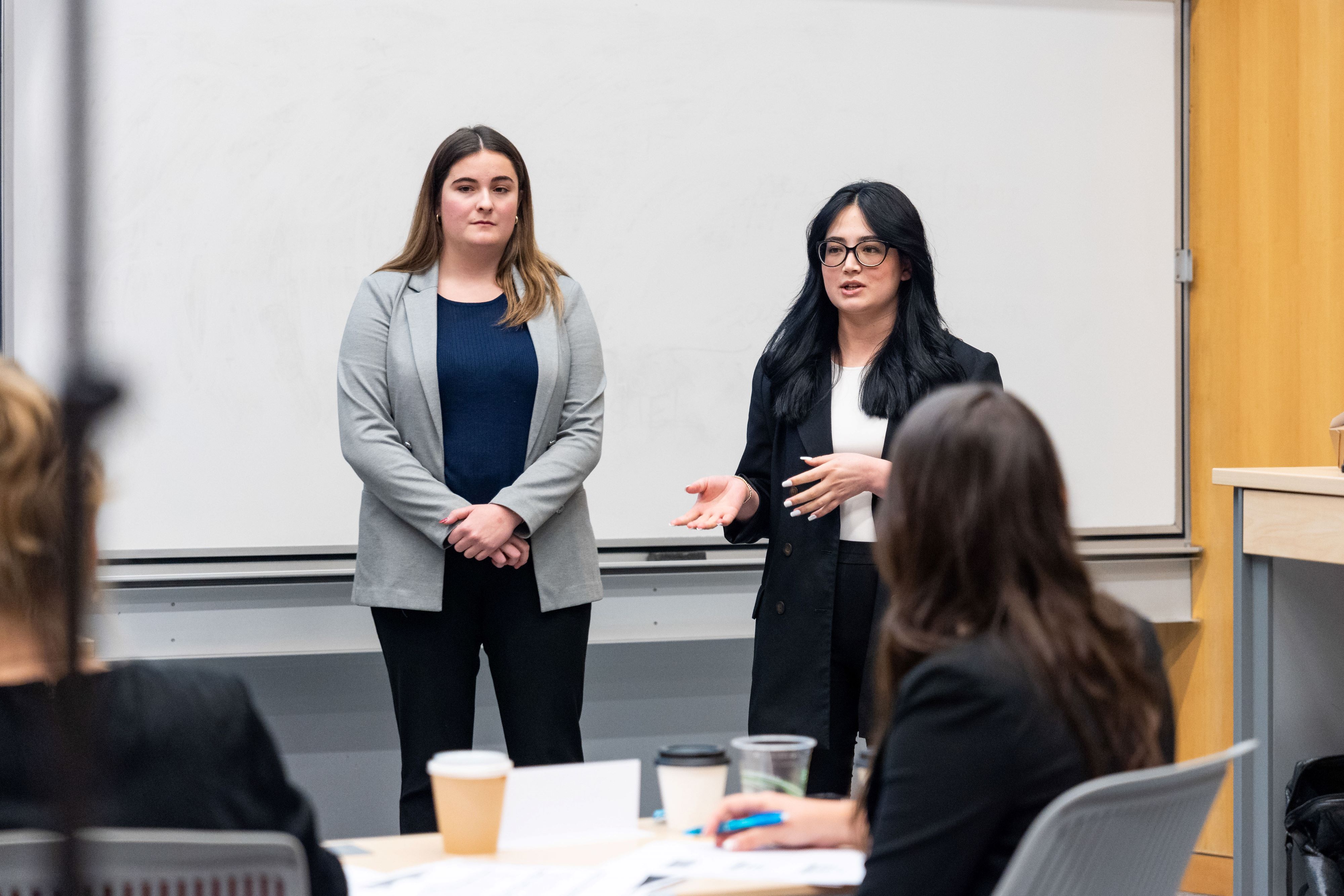 Telfer students presenting their solution in front of a panel of business executives.