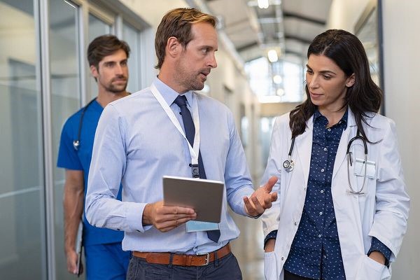 Three medical professionals in a hallway