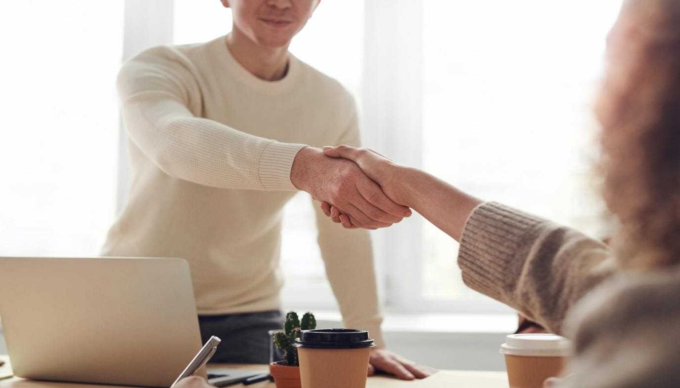 Two people shaking hands in an office