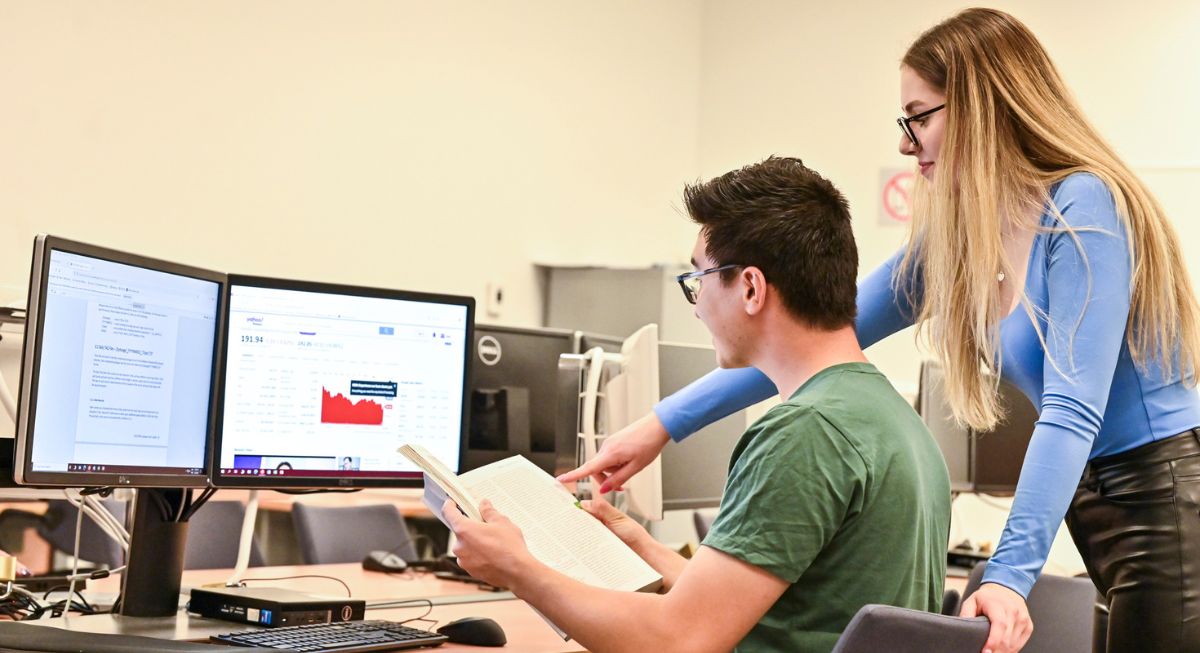 Two Telfer students working together in the Financial Research and Learning Lab.