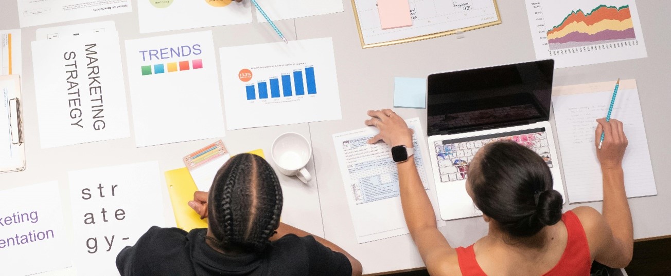 – Two women working and looking over business documents