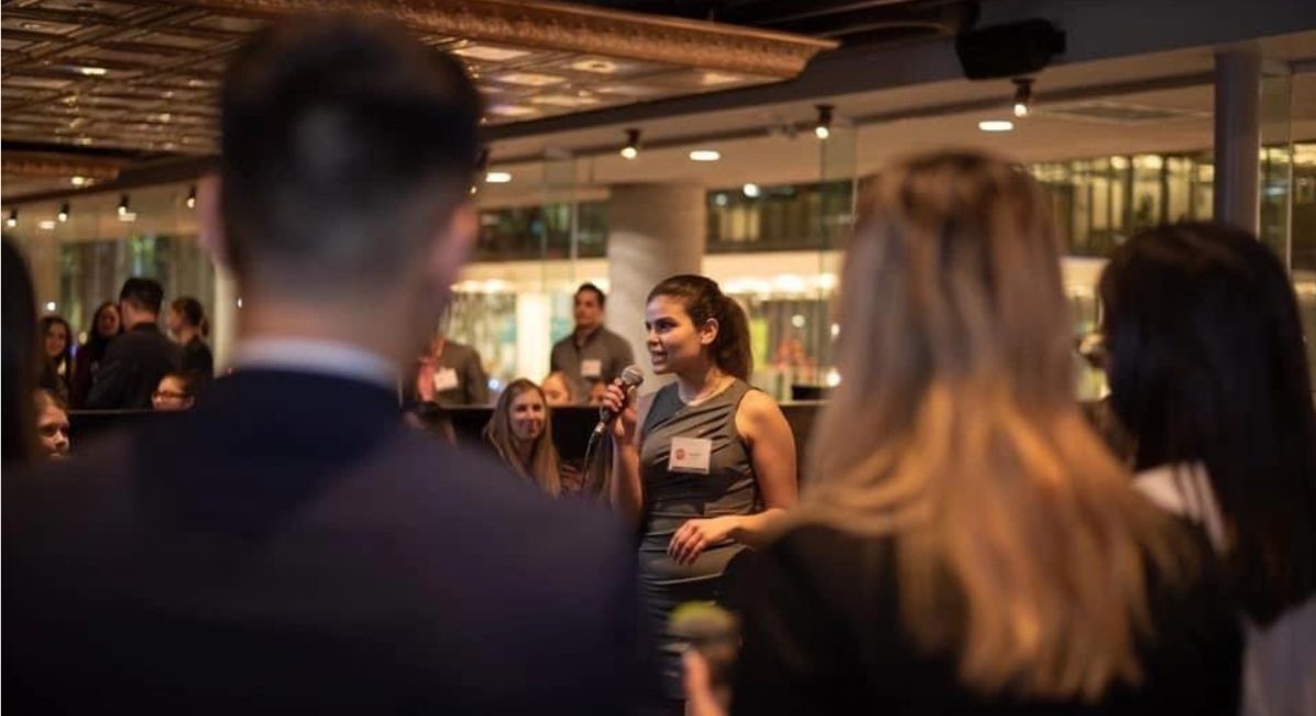 Woman giving a speech at a networking event.