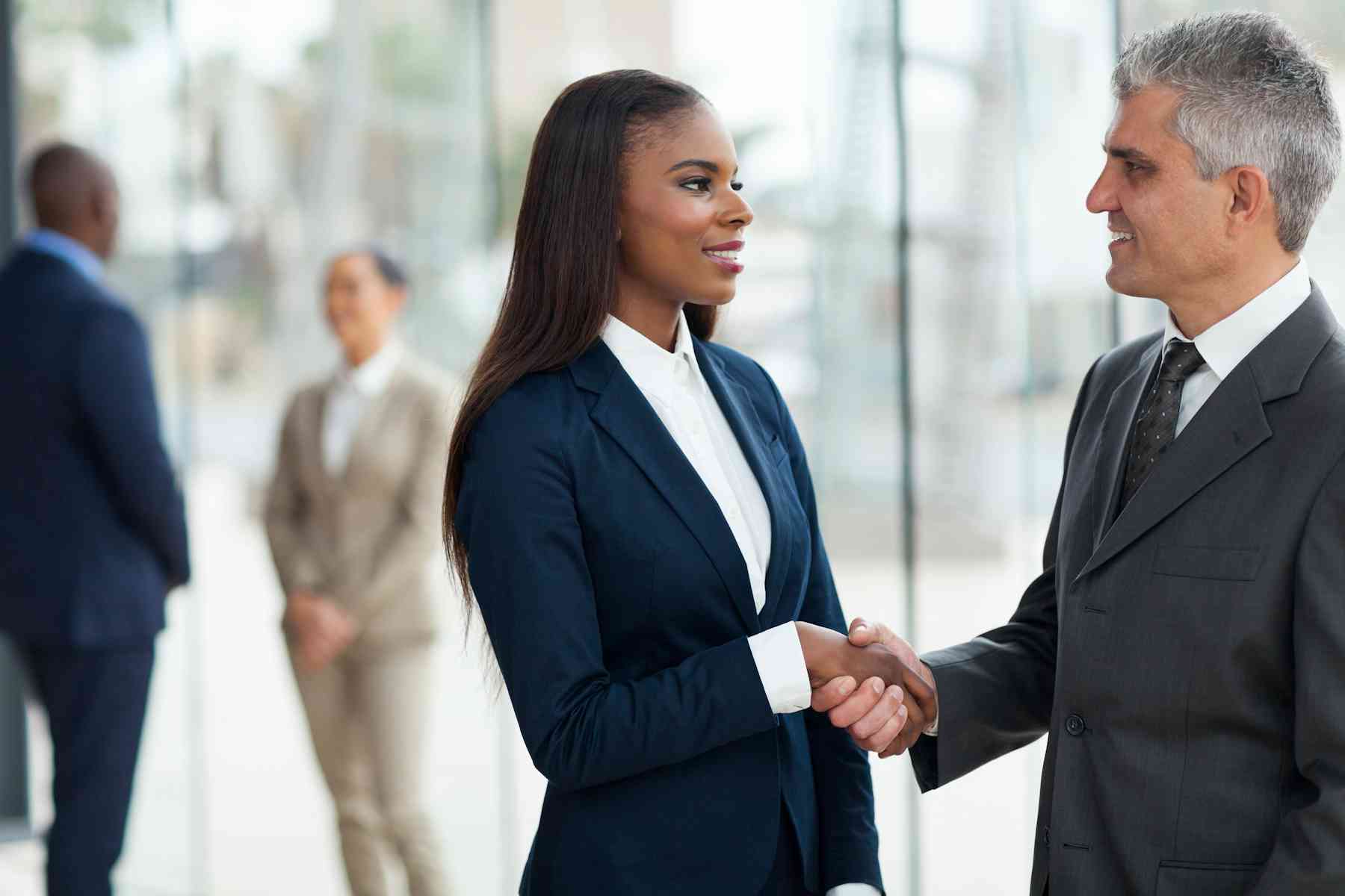 woman shaking hands with a man